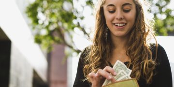 Teen removing money from wallet